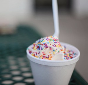 sundae served in a plastic cup with sprinkles